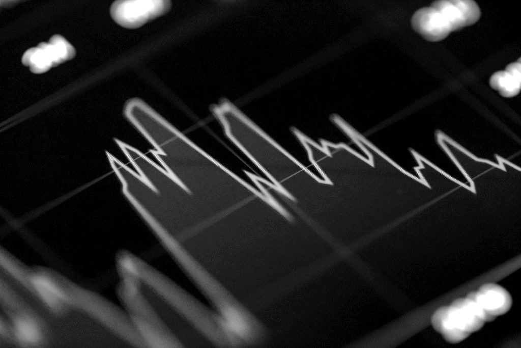 A red line chart on a dark screen