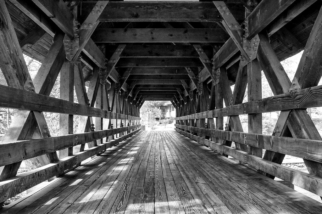 Inside a timber covered bridge, in black and white