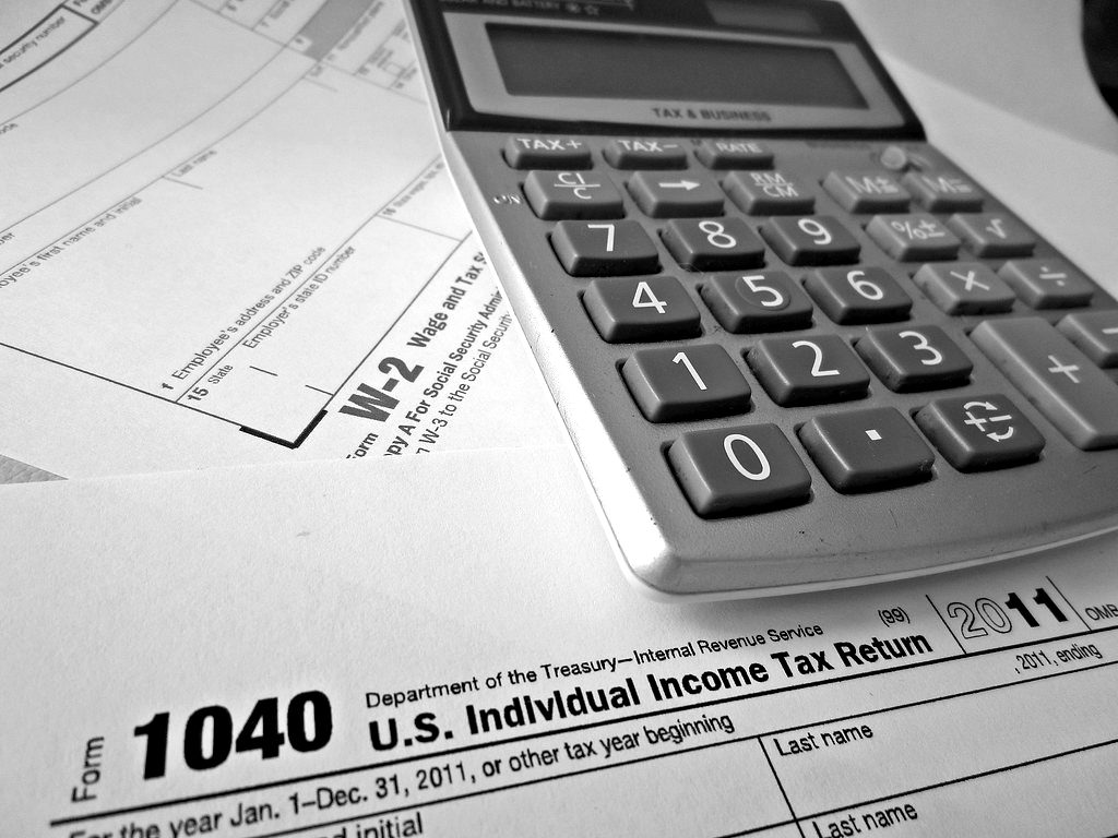 A calculator lying on a W-2 form and a Form 1040