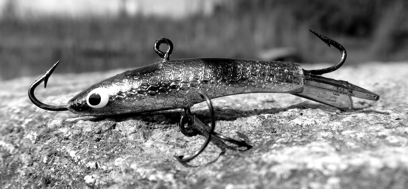 A small fishing lure with a sharp treble hook