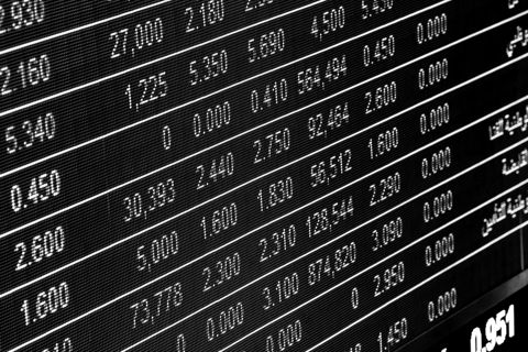 An electronic stock board showing rows of share prices
