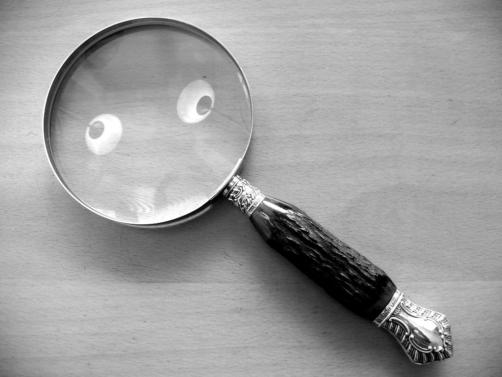 An antique magnifying glass on a wooden table