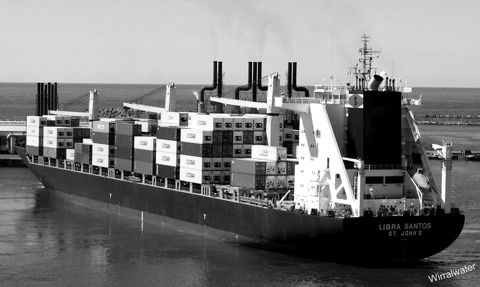 A container ship loaded with cargo leaving port