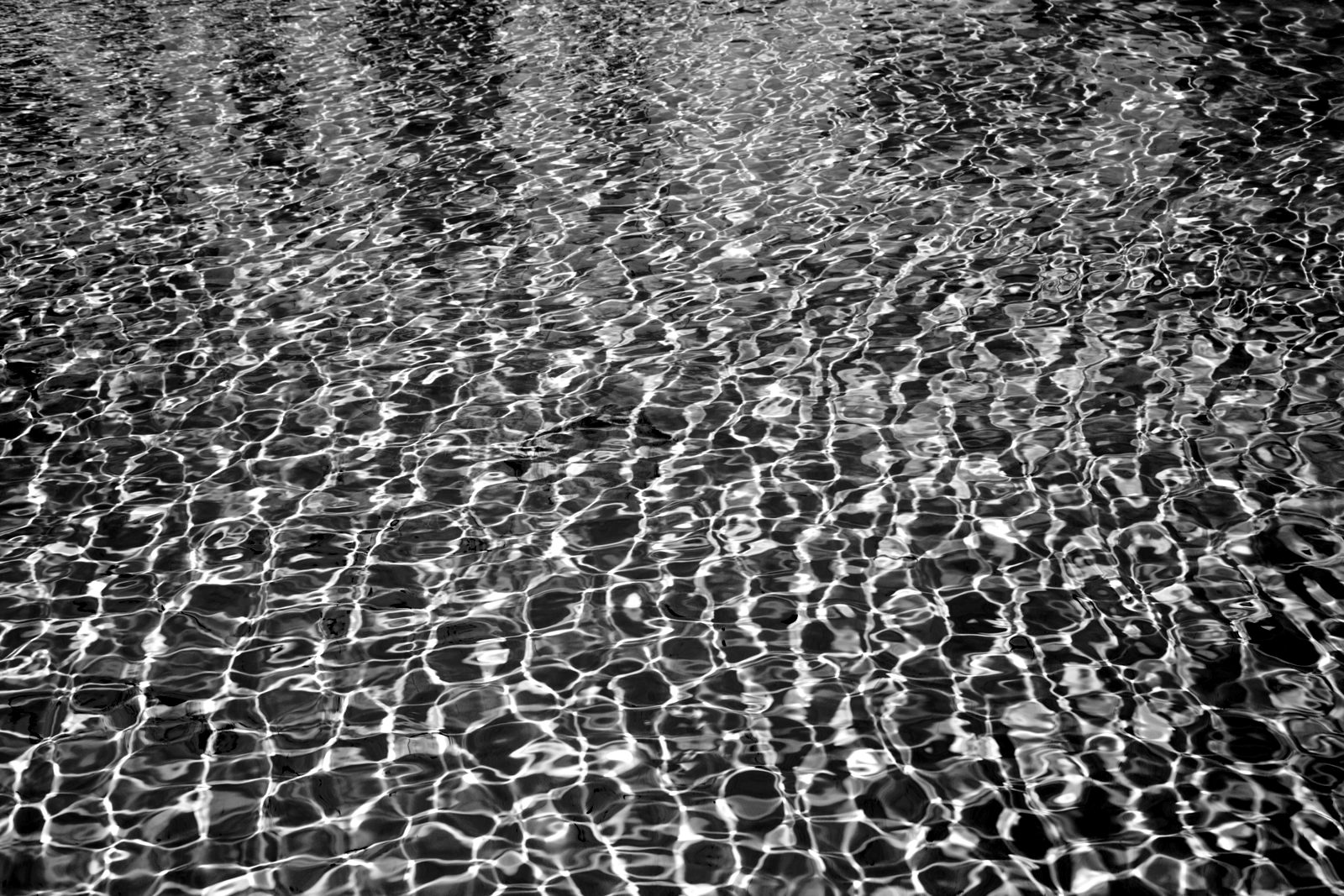 Sunlit ripples across a turquoise pool