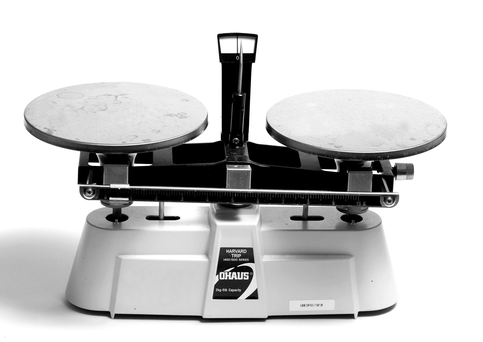 A two-pan mechanical balance on a white background