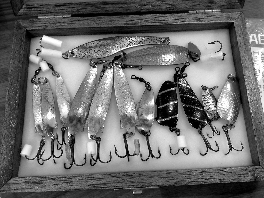 A box of metal fishing spoons and hooks