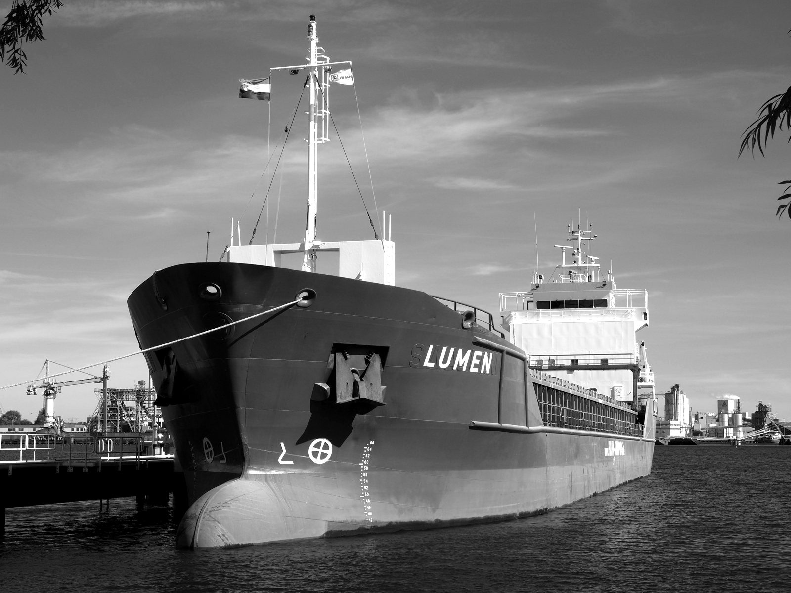 A cargo ship moored at a harbour quay