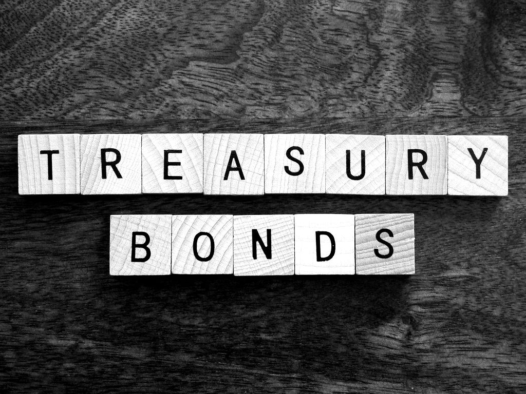 Letter tiles spelling 'Treasury bonds' on wood